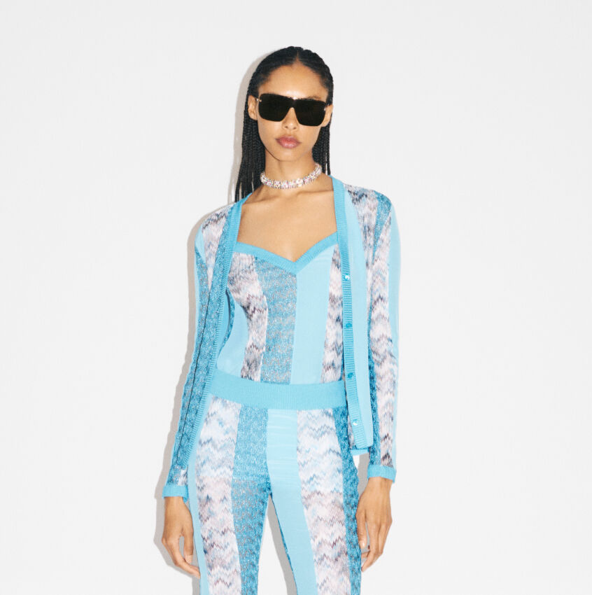 The model is wearing a blu patchwork outfit from the new Spring Summer 2023 collection