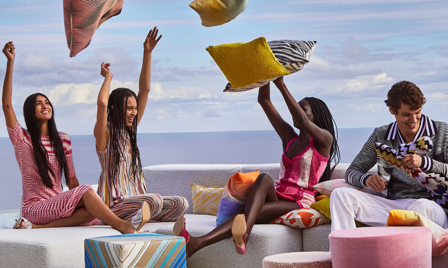 Models are throwing up in the air different multicoloured pillows from the 2023 Home collection